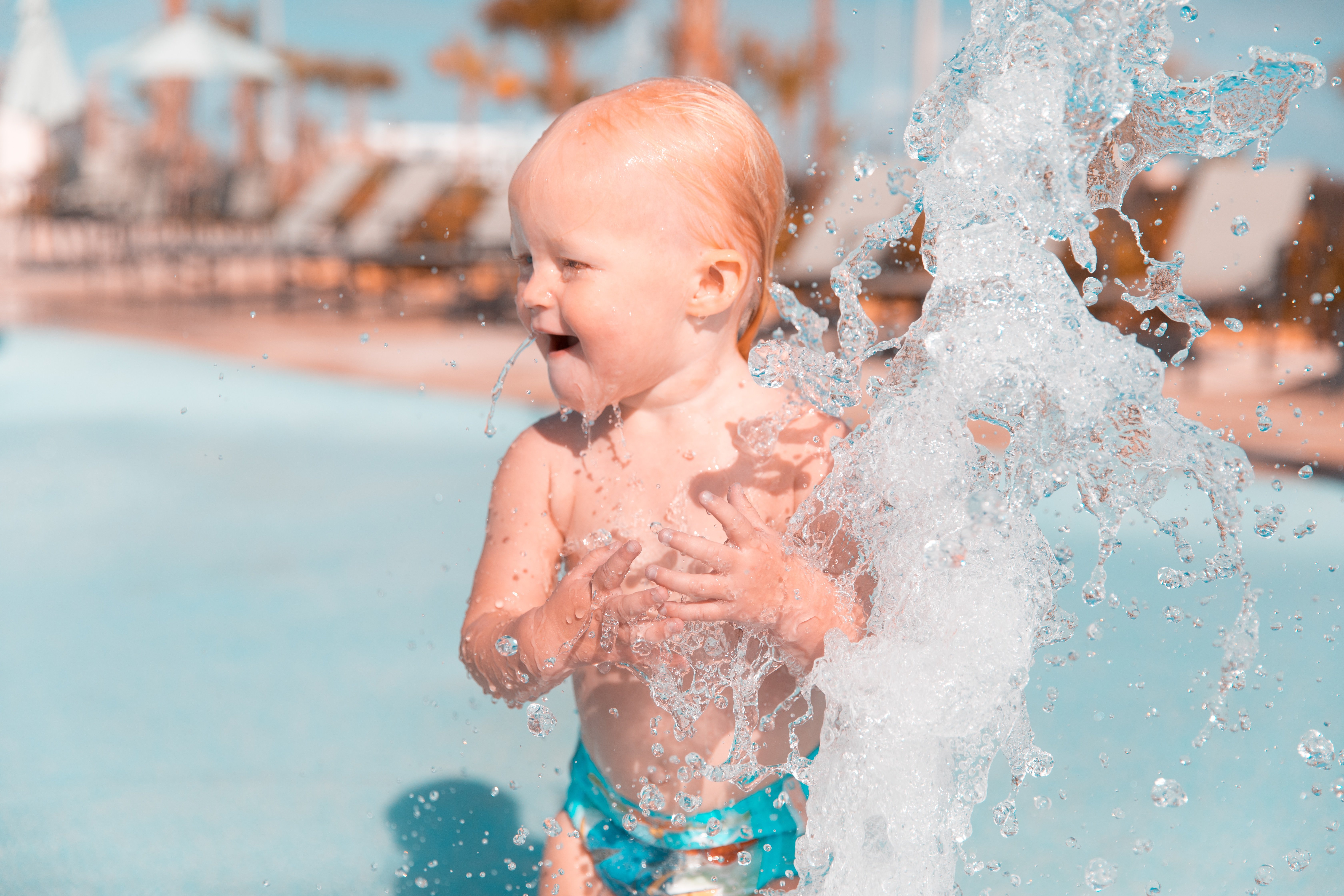 Young child playing in outdoor pool